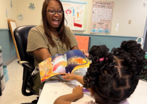 BCBA is using ABA Therapy techniques to teach child in mock classroom setting.