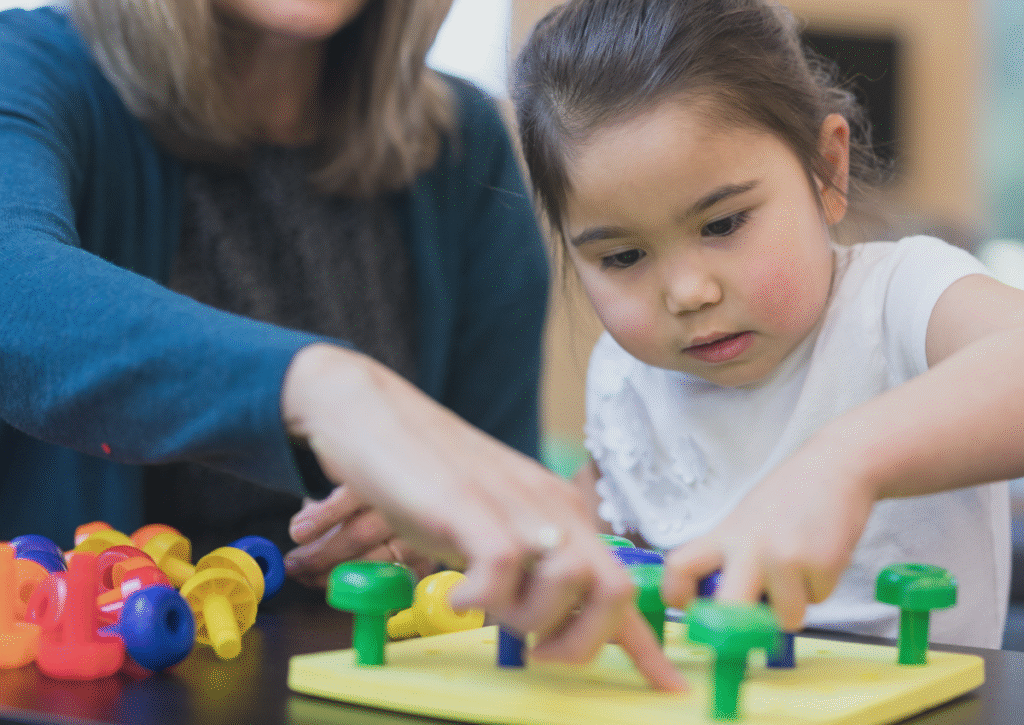 Therapist helping child with motor skills activity.