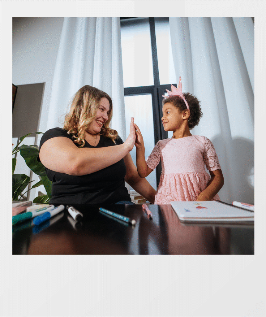 woman and little girl high-fiving